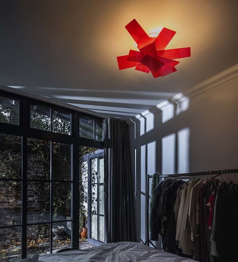 Plafoniera Foscarini Big Bang rossa a lastre incrociate in un soggiorno