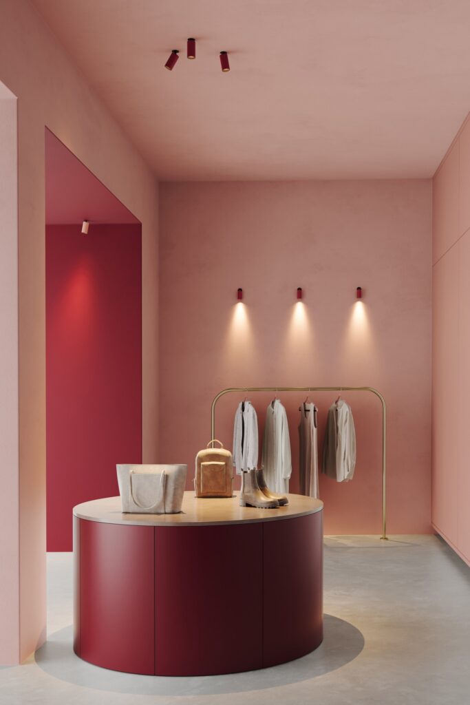 Negozio rosa con i proiettori Modular Nyto a soffitto sopra il bancone
