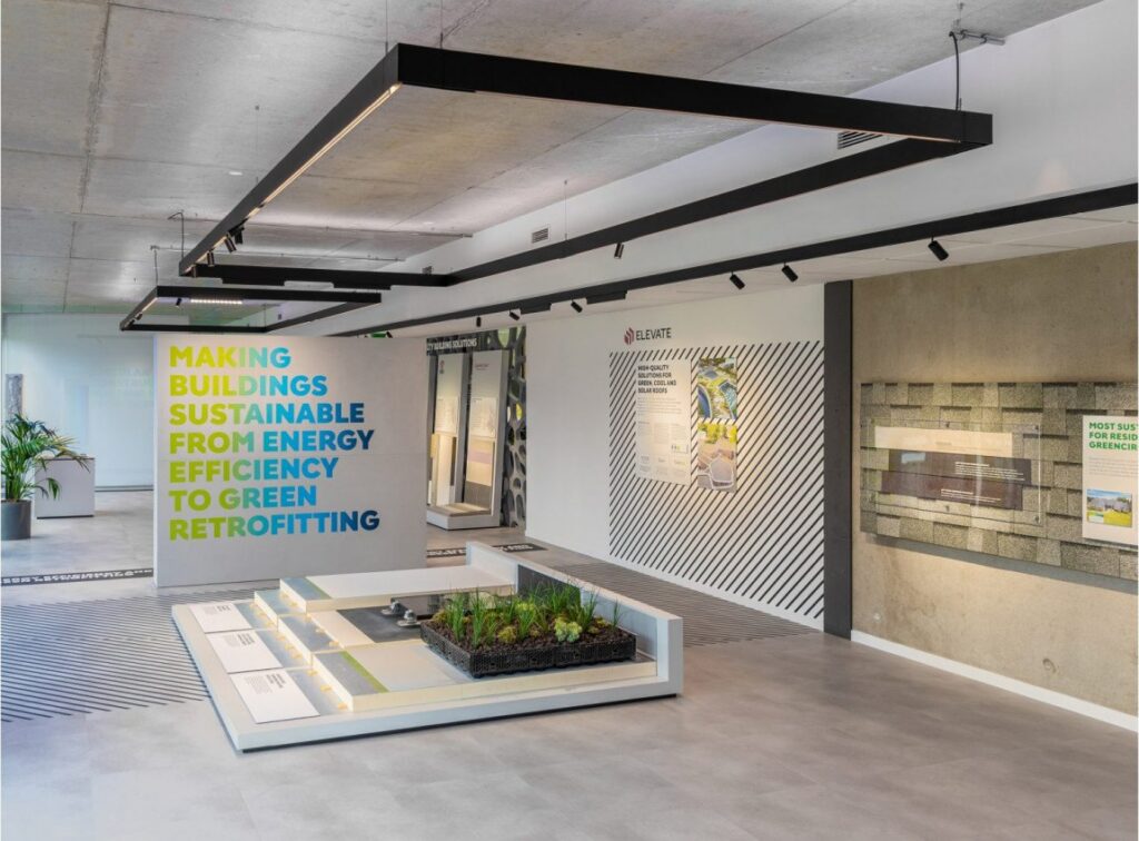 Showroom Holcim con gli spazi di lavoro illuminati dalle linee Reggiani